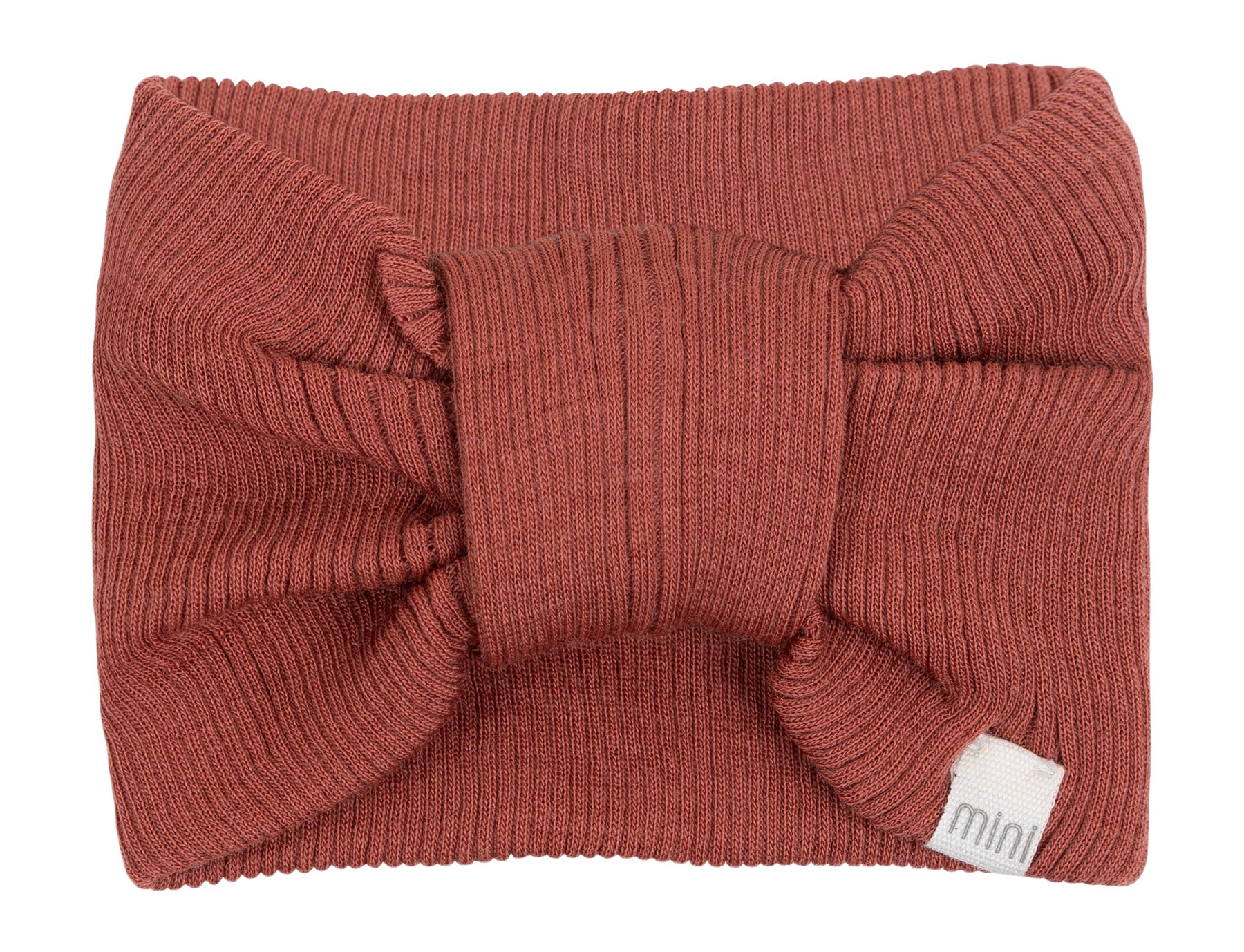 „minimalisma Stirnband ‚Alba‘ in Autumn Blush – geripptes Kinder-Stirnband aus Merinowolle, flach liegend auf hellem Hintergrund“