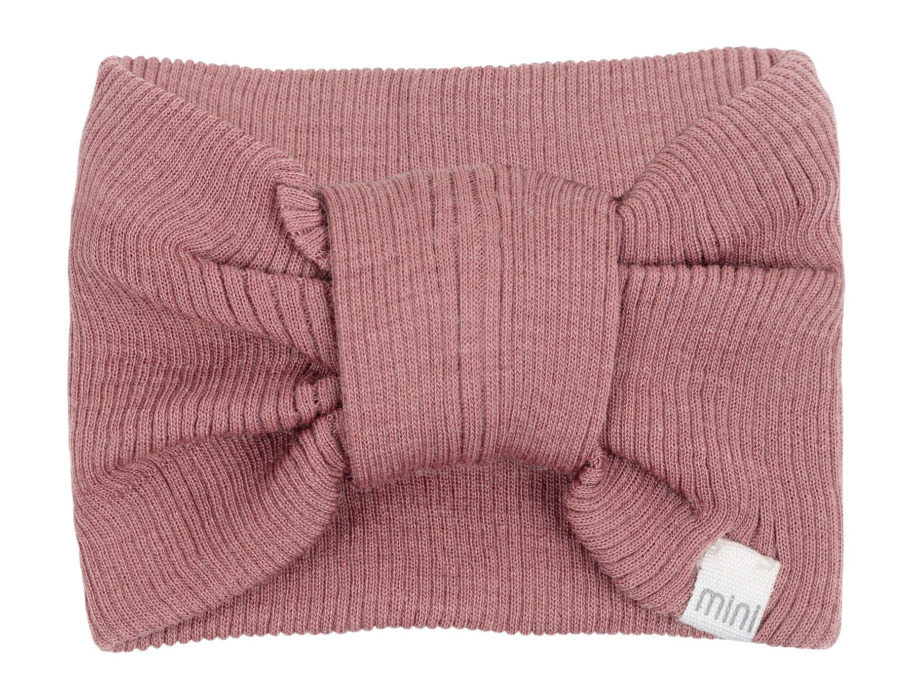 „minimalisma Stirnband ‚Alba‘ in Rose– geripptes Kinder-Stirnband aus Merinowolle, flach liegend auf hellem Hintergrund“
