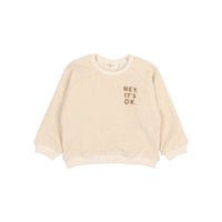 Búho Kinder-Sweatshirt in Ivory aus Frottee mit Print auf der Brust, Raglanärmeln und Druckknopfverschluss am Rücken.