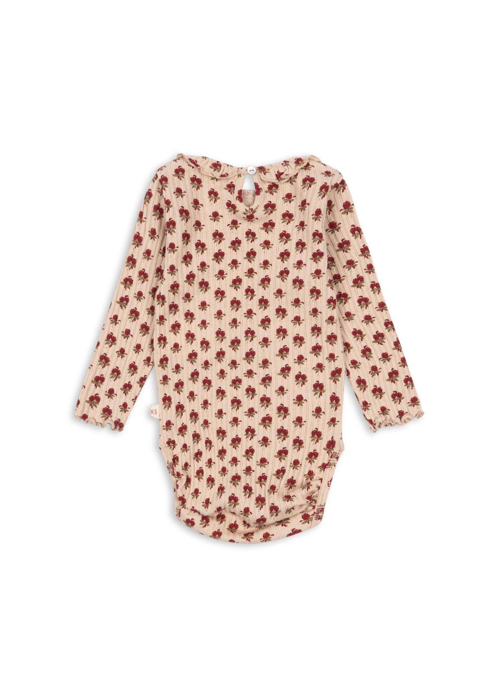 Konges Sløjd Body Nola in Ruby Rose – langärmeliger Babybody aus Bio-Baumwolle mit Rosenprint und Rüschen an den Schultern.